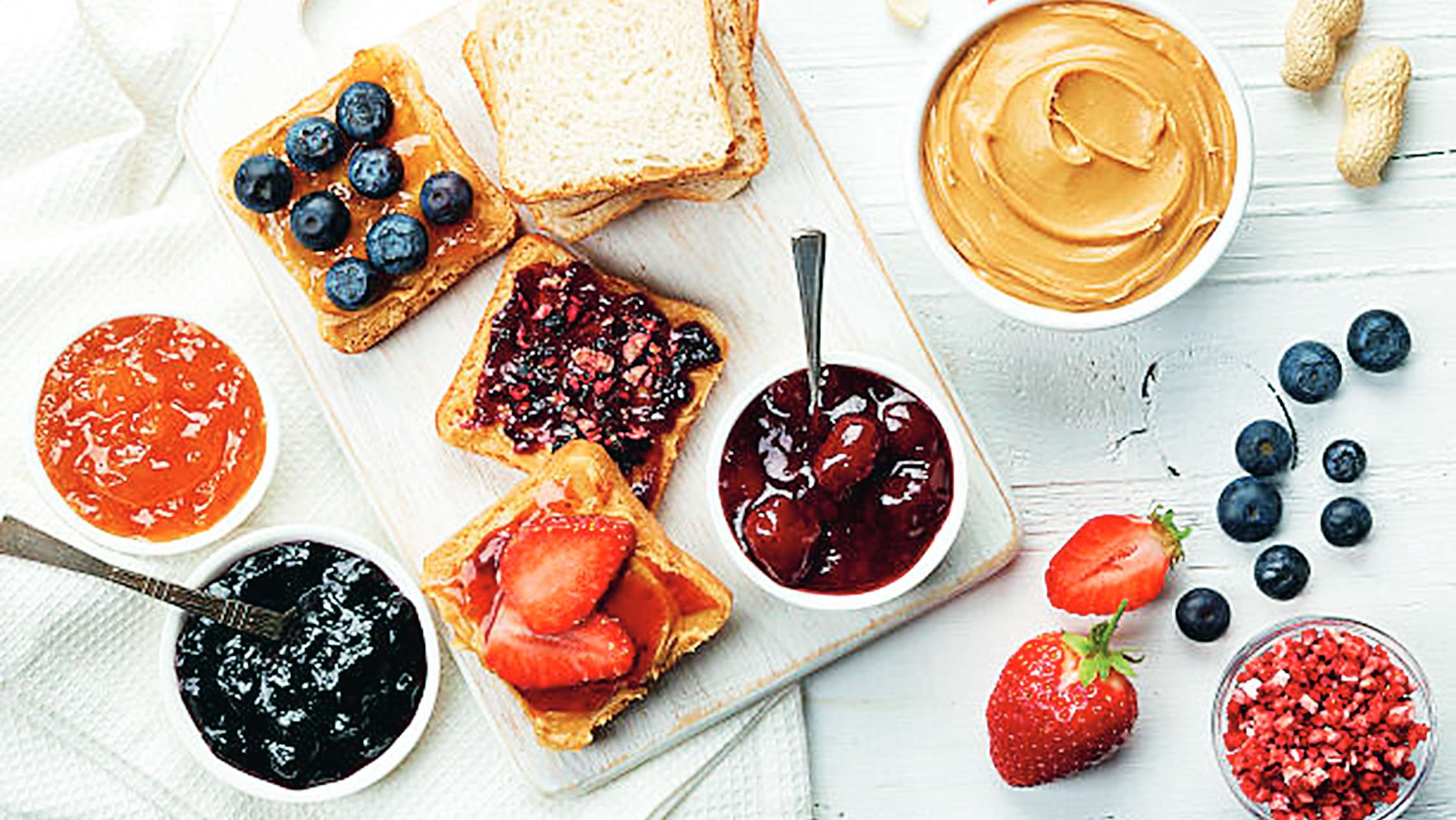 Sandwiches with peanut butter, jam and fresh fruits.